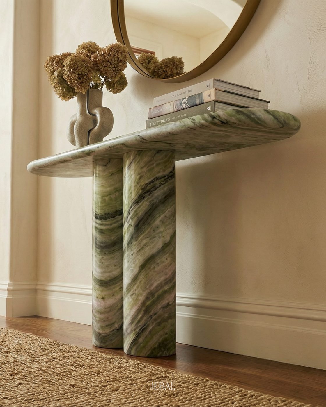Shangrila green quartzite console table beneath a round mirror