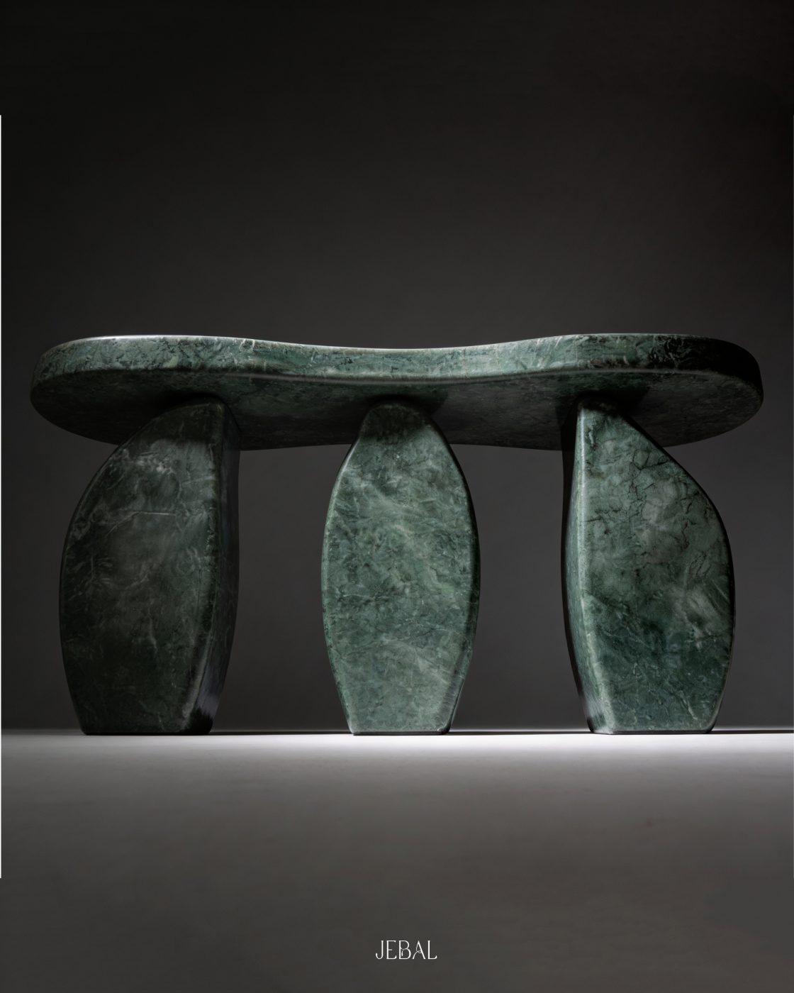 Verde Alpi green marble console, a curved top resting on three sculptural legs