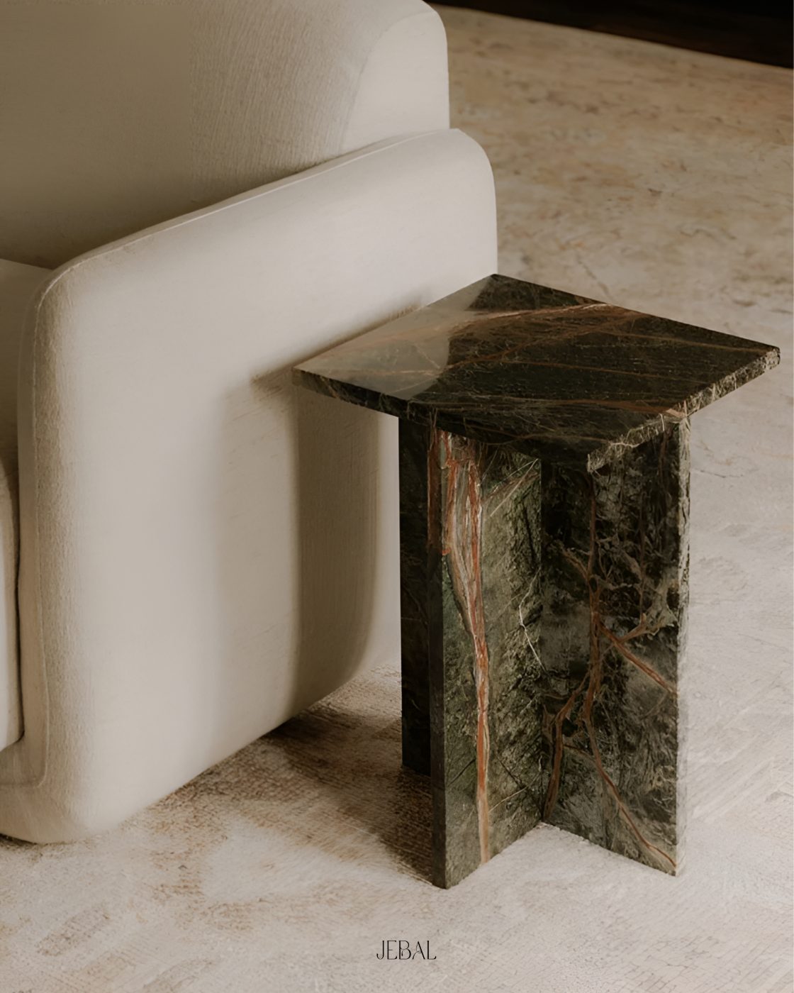 Rainforest green marble coffee table beside a cream sofa