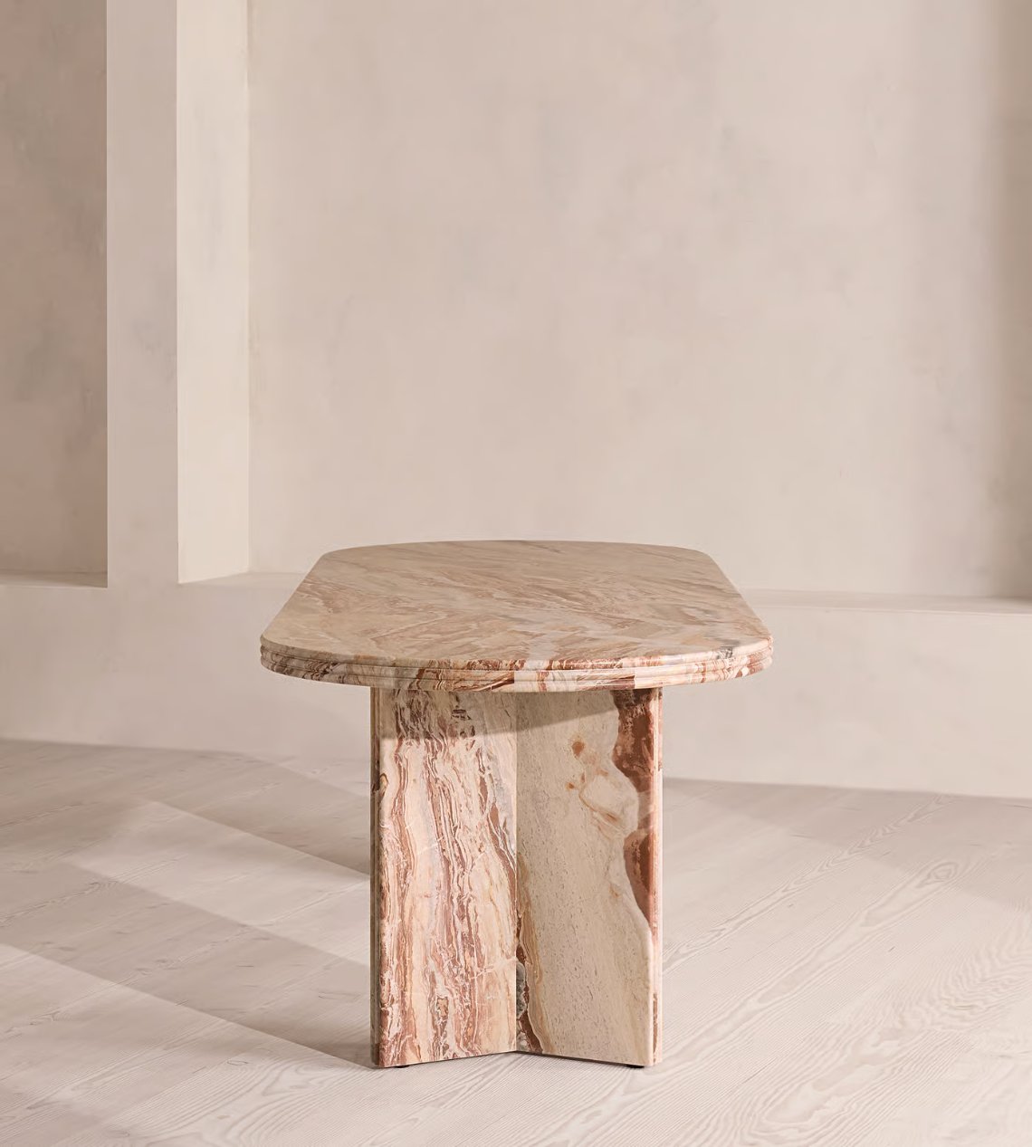 Rosso Orobica marble table viewed at an angle in the atelier