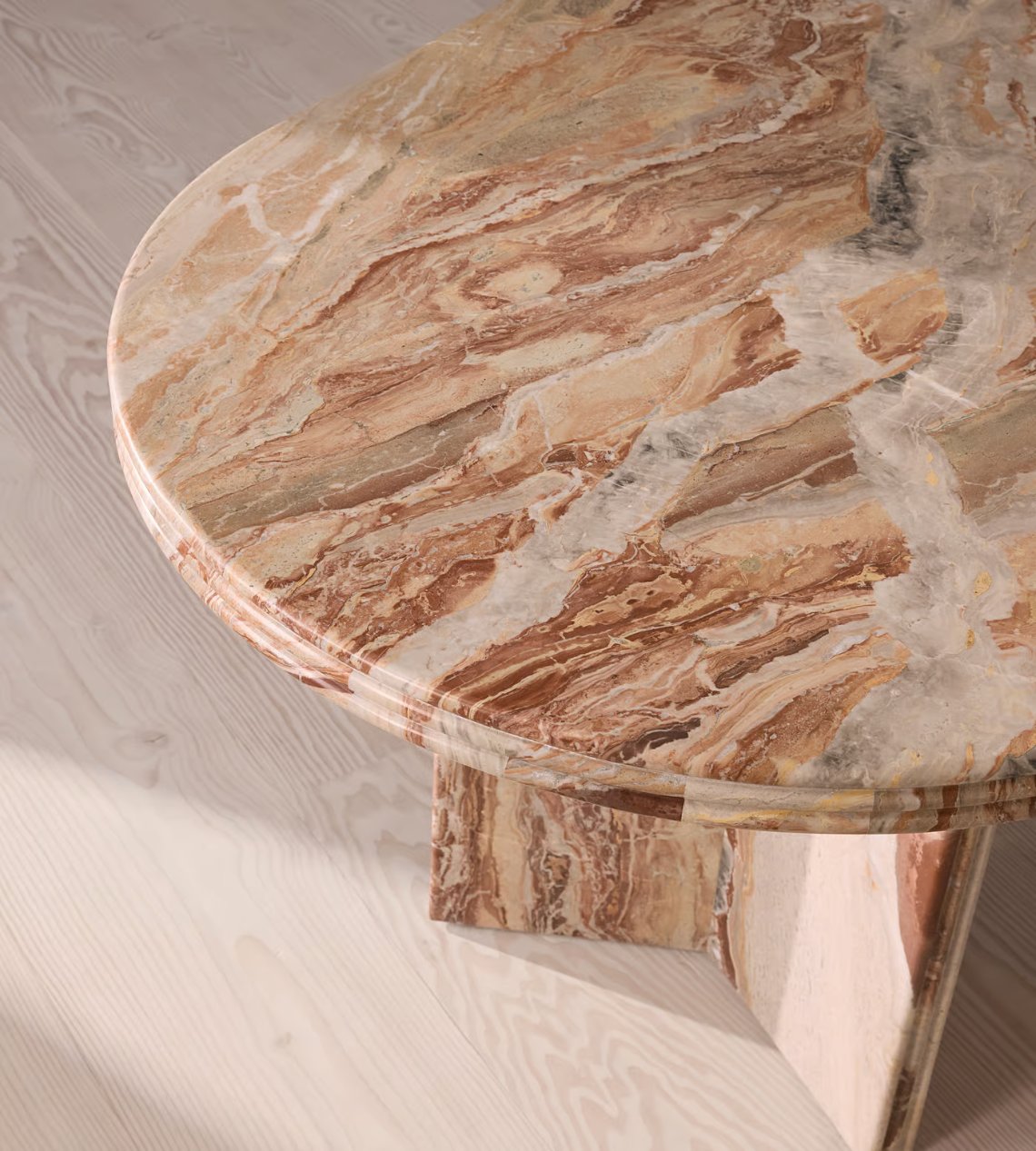 Rosso Orobica marble surface — warm rust with white quartz veining