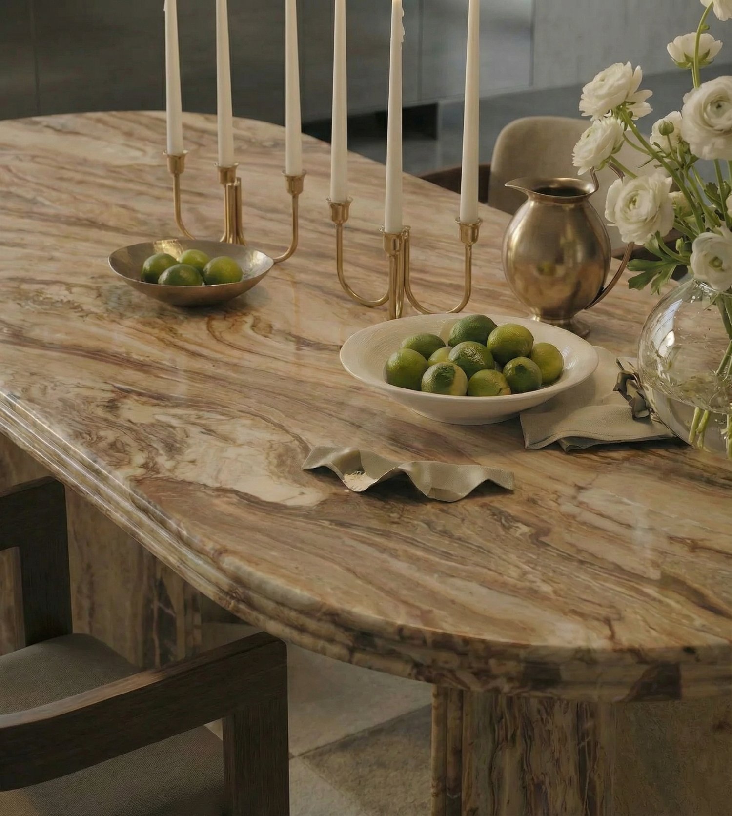 A continuous vein of Rosso Orobica marble running unbroken across a single hand-finished table top